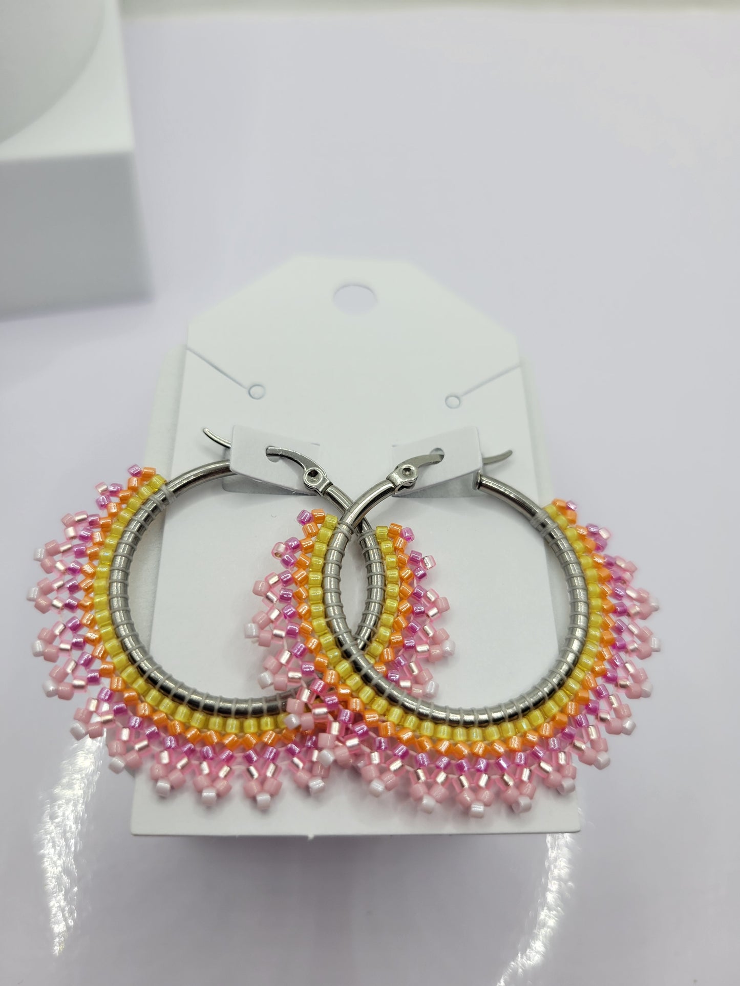 Multi-colored seed bead hoop earring