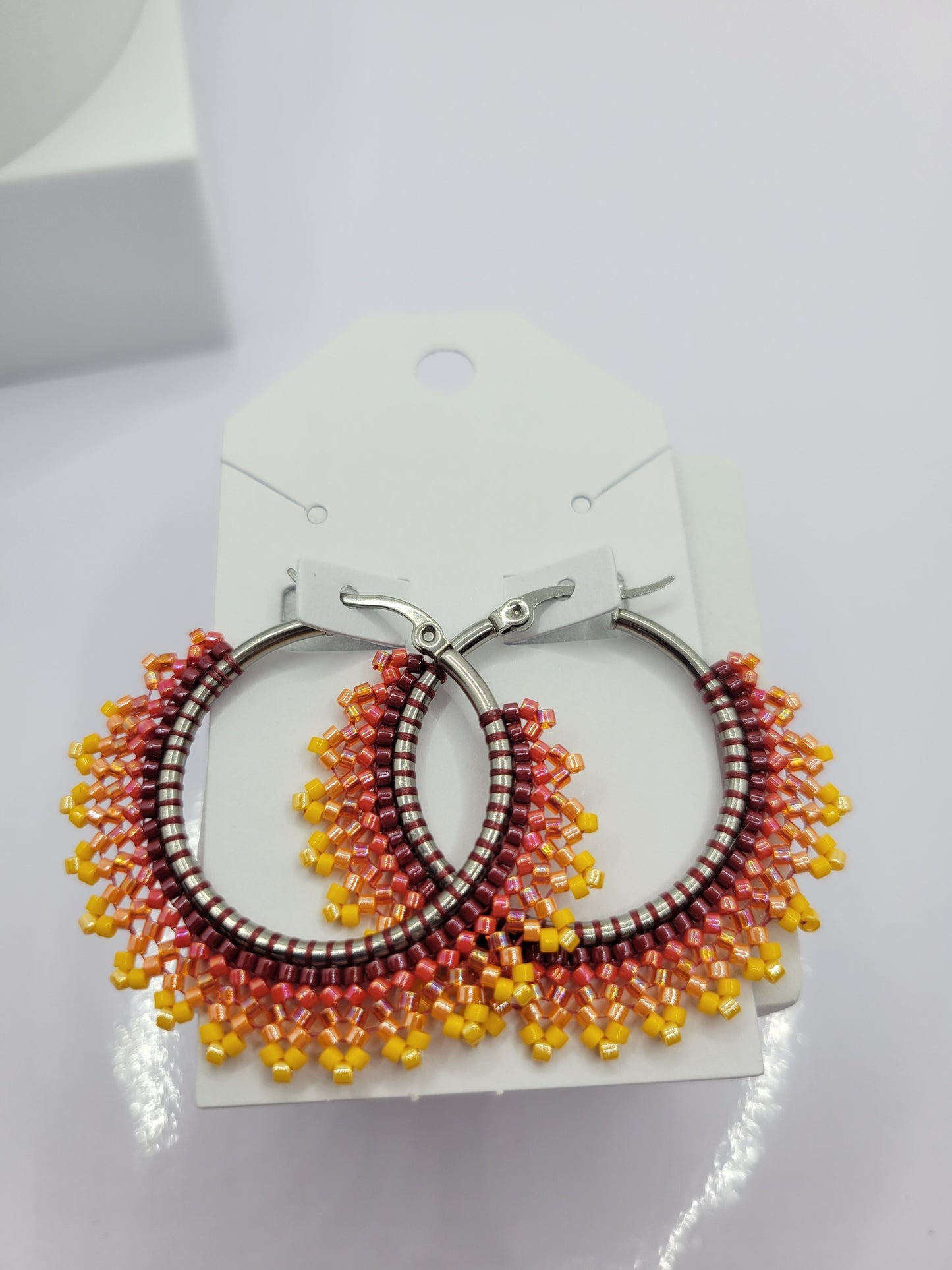 Multi-colored seed bead hoop earring