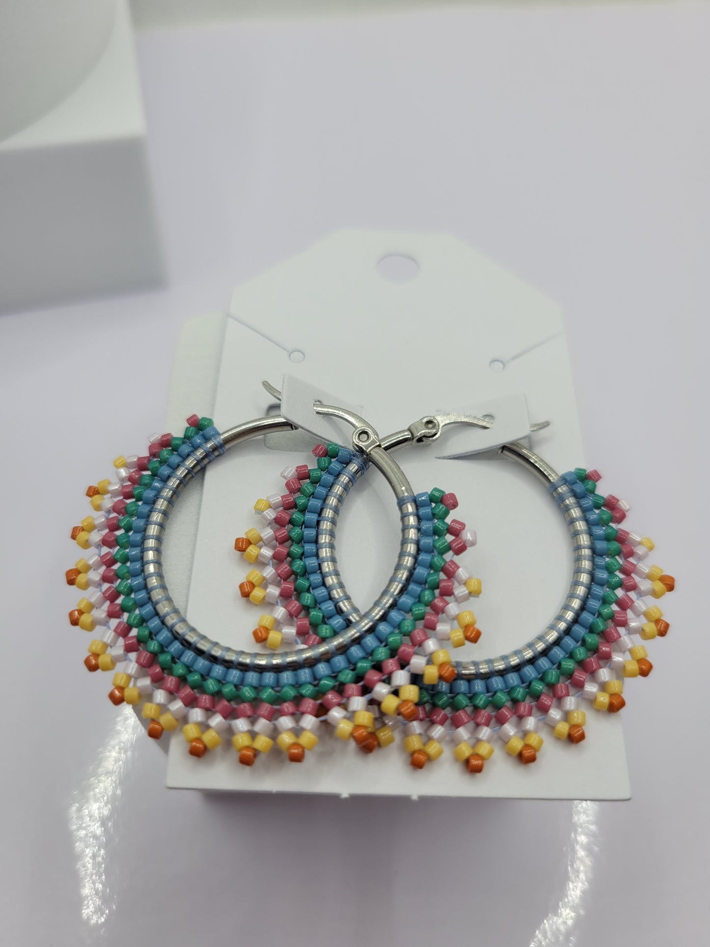 Multi-colored seed bead hoop earring
